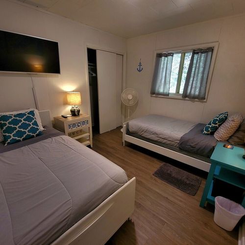 Bedroom #3:  bedroom #3 features two twin-size beds, a closet, and nightstands with lamps.