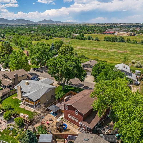 The drone captures a breathtaking scene with a majestic mountain range stretching across the horizon, offering a stunning backdrop that enhances the natural beauty of the surroundings.