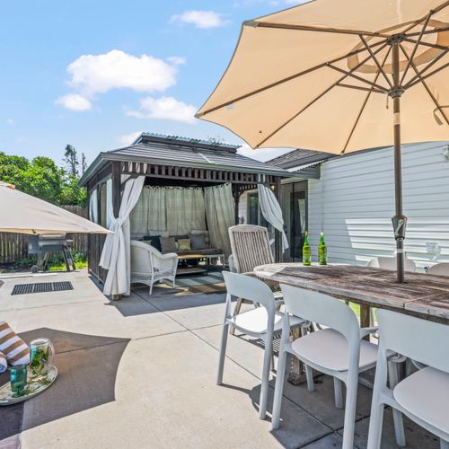 Covered patio steps from the pool, ideal for shade and relaxation.