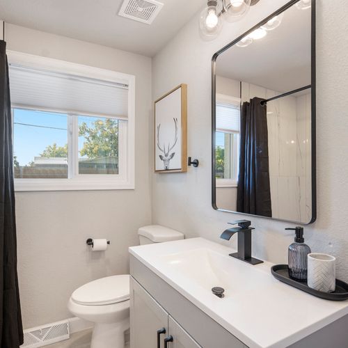 The upstairs hall bathroom features a spacious walk-in shower, providing convenience and comfort for guests.