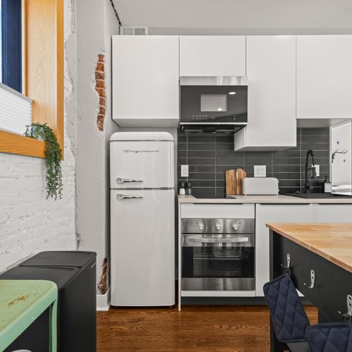 Cook comfortably in a stocked kitchen complete with fridge, toaster oven, and microwave.