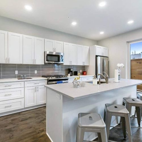 Clean, fully equipped kitchen w/ island seating — ready for your next home-cooked meal.