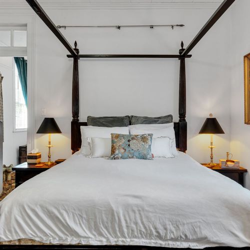 Dreamy four-poster king bed dressed for deep, restful nights.