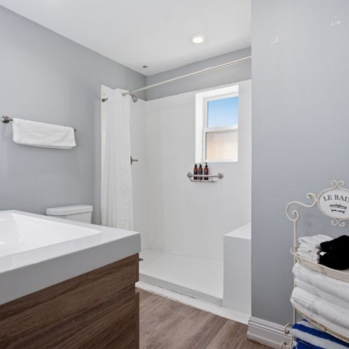 Bright, tidy bathroom w/ modern fixtures & a calm, airy feel.