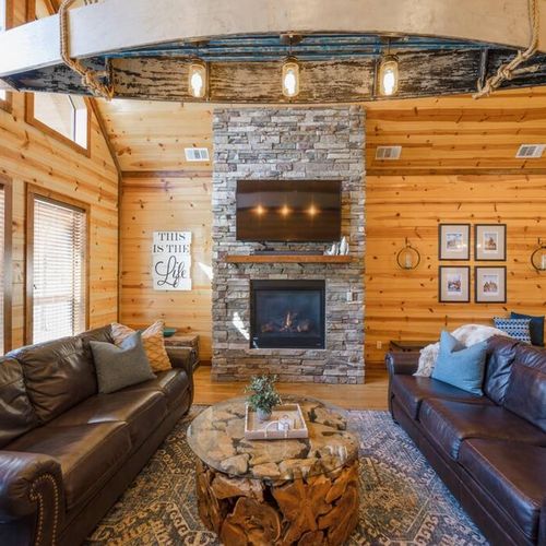 The main living room is the heart of the cabin with 2 sofas and a gas fireplace!