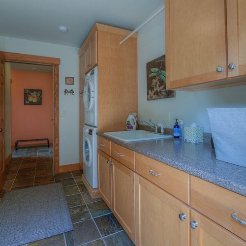 Laundry room with a Bosch stackable washer and dryer.