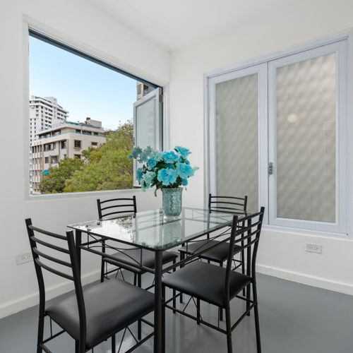Enjoy city views through the expansive window as you dine in style.
