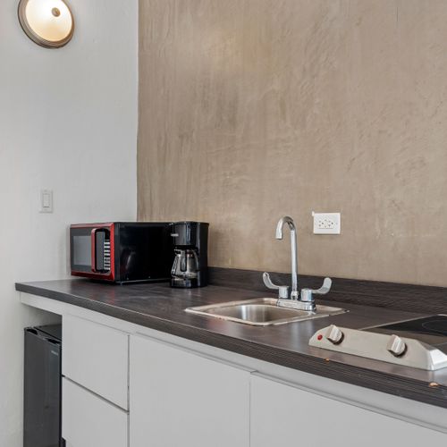 Start your day right! Our convenient kitchenette is equipped with essentials like a coffee maker, perfect for brewing your morning cup before heading out to explore or simply relaxing in.