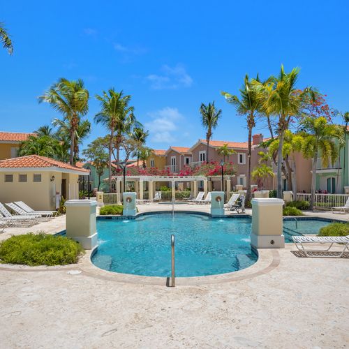 Relax under the shade of our palm tree while enjoying a refreshing dip in the pool.