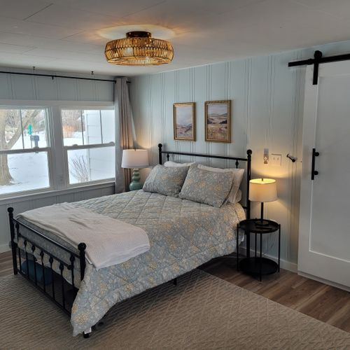 Bedroom #1:  bedroom #1 is the primary bedroom. It features a queen-size bed, ceiling fan, live streaming television, nightstands, lamps, a closet, a large dresser, a desk, and a comfy chair. There is also a door from the bedroom to the garage. (the door is fully lockable. )