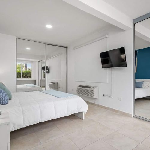 A cozy bedroom with a TV, adding a touch of home comfort.