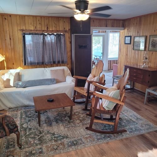 Living room #1:  the home has a cozy living room in the center of the cabin with a sofa, 3 chairs, and a coffee  table.