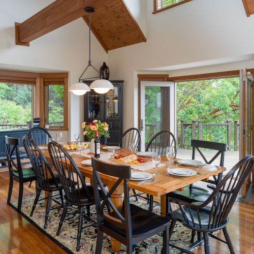 Large dining table that seats ten and opens to the outdoors.