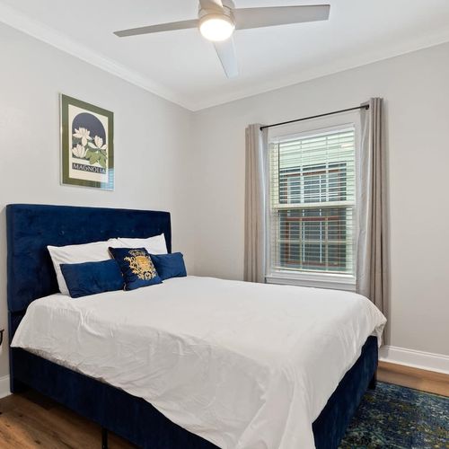 Bright first bedroom w/ a comfy queen bed down the hall.