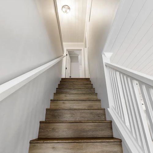 STAIRS:  The are the stairs up to the upper level of the home (i.e. the third floor), which features 3 bedrooms and 2 bathroom.