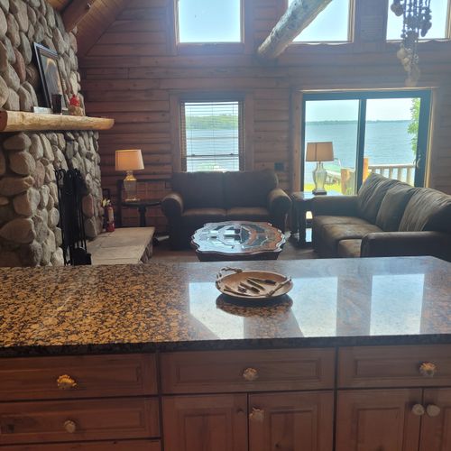 Lving room:  the view of cute and cozy living room from behind the kitchen counter showing the view of van etten lake