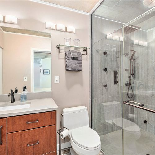 Our master room bathroom offers a refined experience with a rainfall showerhead for a spa-like feel and a handheld shower attachment for added convenience.