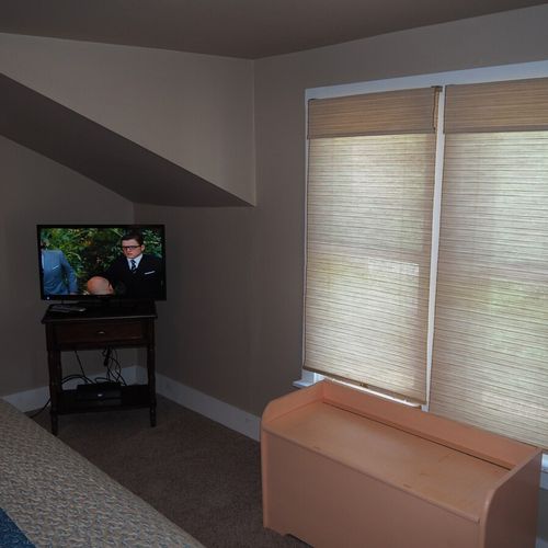 Bedroom #1:  features a queen-size bed, mirror, nightstands, lamps, dresser, chair, and television.