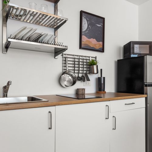 his bright kitchen area combines functionality and comfort with modern appliances.