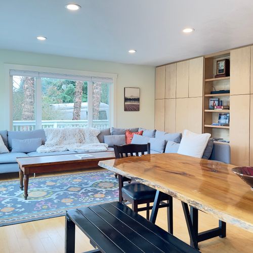 A bright, comfortable living and dining space with room to relax and gather. Stretch out on the sofa, enjoy meals at the table, or curl up with a book while natural light and forest views fill the room.