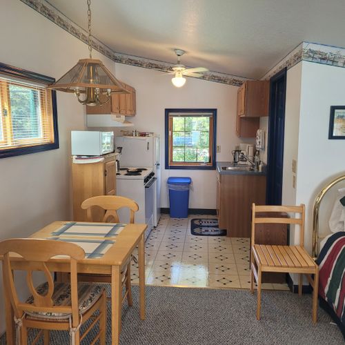 Main room:  the dining table with the kitchen in the background