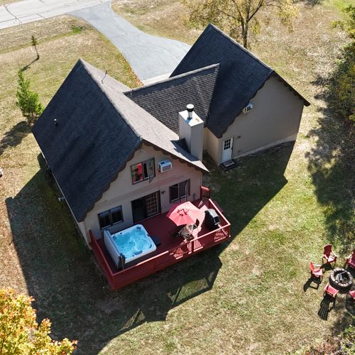 OVERVIEW:   Aerial view highlighting the backyard deck, new hot tub, outdoor dining furniture, new gas grill, and bonfire ring.