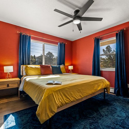 The secondary bedroom offers tons of natural light and is outfitted with a comfortable king, and side tables with lamps.