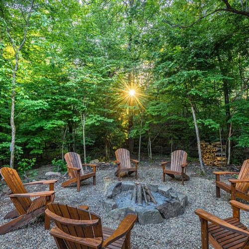 Large outdoor firepit and chairs surrounding.