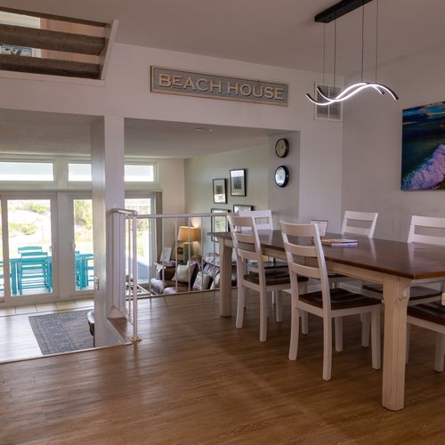 Seamless flow from dining area to patio, illuminated by natural daylight.