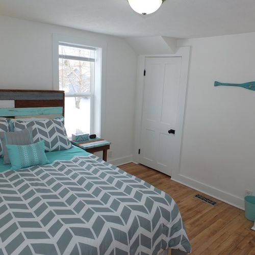 Bedroom #1 (downstairs):  another angle showing the decorative oar that has hooks for hanging clothes.