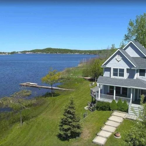 Overall:  a nice aerial view of the house with betsie lake right next to the house and downtown frankfort and lake michigan in the distance.