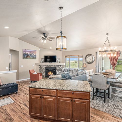 A modern kitchen with stainless steel appliances and a sleek granite countertop, perfect for preparing your favorite meals, just like at home.