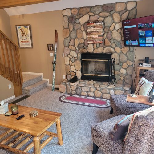 LIVING ROOM:  Adorable and very comfy living room with wood fireplace, sofa, coffee table, comfy chairs, and live streaming television (via Sling).