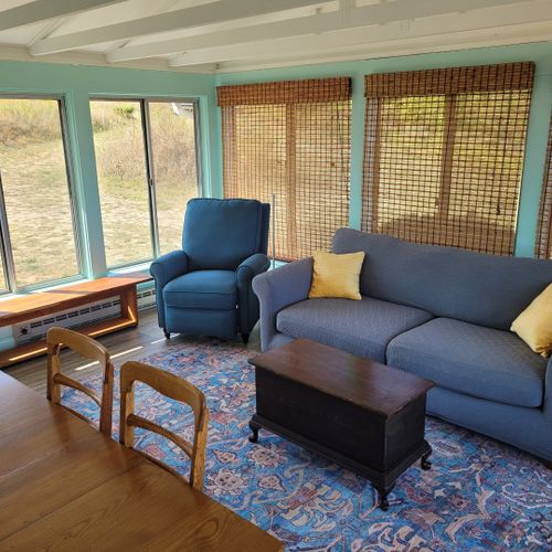 Sunroom:  the cottage has a very fun and family-friendly sunroom with a dining / game table, sofa, comfy chair, and a great view of crystal lake