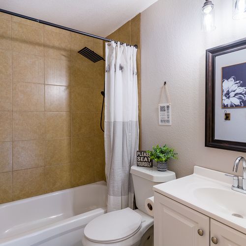 Upstairs full bath is outfitted with a shower/tub combo and conveniently placed towel hooks.