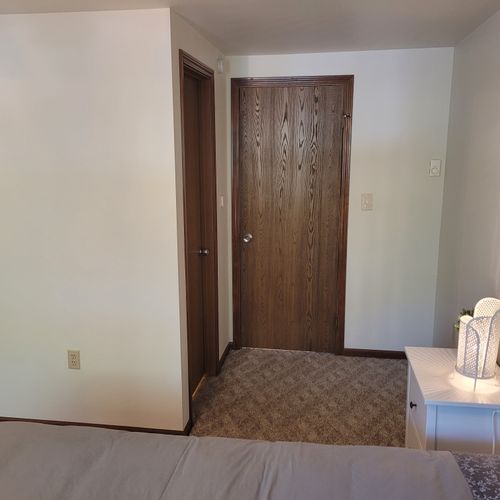 Bedroom #1:  features a sleep number adjustable queen-size bed, closet, ceiling fan, nightstands, and lamps.