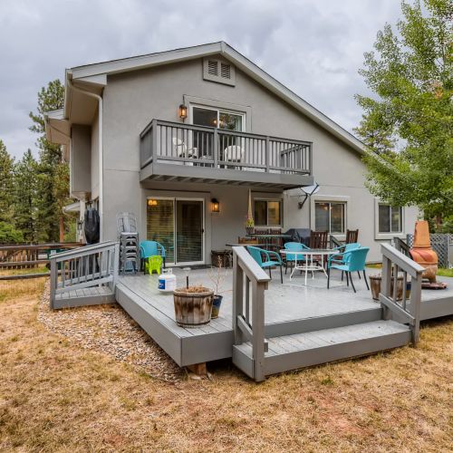 A massive back patio awaits with plenty of seating. Chiminea has been removed due to wildfire risk.