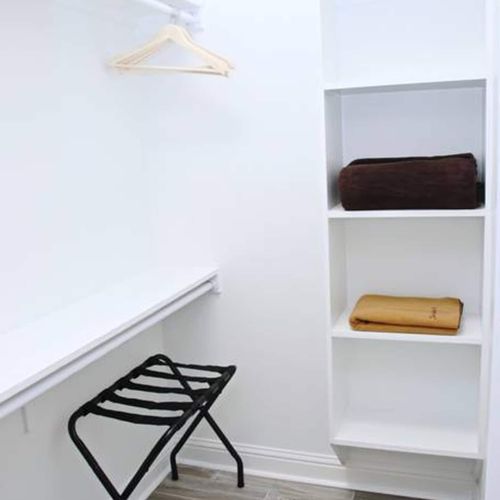 Clean, minimalist bedroom w/ built-in storage for a clutter-free stay.
