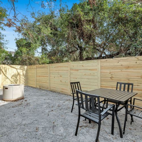 Private fenced patio w/ a dining table & chairs — your own outdoor retreat.