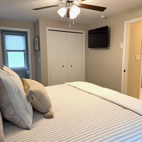 Bedroom #1:  features a king-size bed, ceiling fan, private television and private en suite full bathroom!