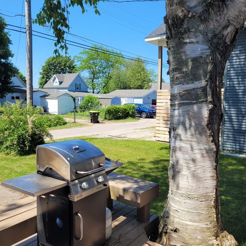 EXTERIOR:  The propane grill on the backyard deck