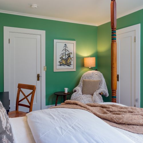 With First Nation original art, vintage reading chair with faux fur, and a walk-in closet, the Green Room is a guest favorite .