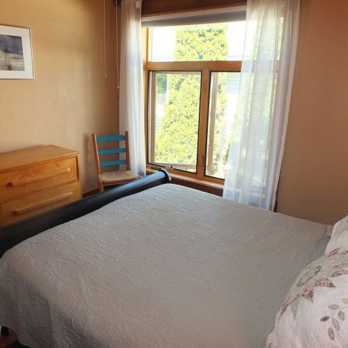 Bedroom #1 (first floor):  features a beautiful queen-size sleigh bed, nightstands, lamps, a ceiling fan with lights, dresser, chair, closet, and its own private entrance to the first floor bathroom.