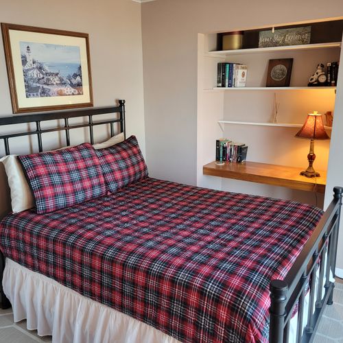 BEDROOM #2 (FIRST FLOOR):  Features a full-size bed, desk, streaming television, closet, private entrance, and a great view of Crystal Lake!