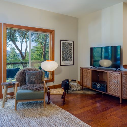 Cozy single couch with TV, balcony access, and WiFi for relaxing and staying connected.