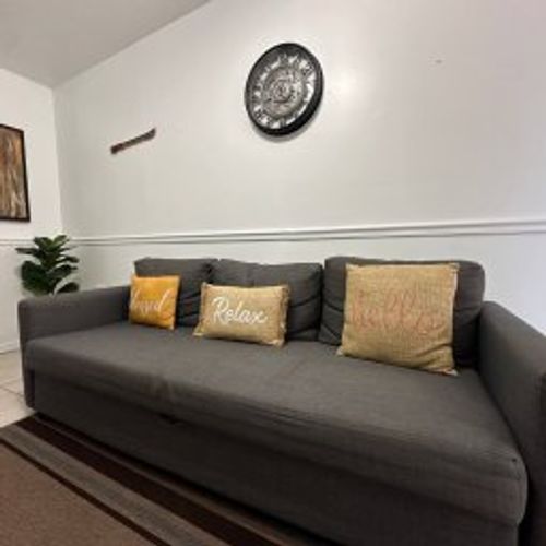 "Relax and unwind in our cozy living area, featuring a comfortable sectional sofa perfect for lounging, watching movies,