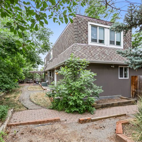 The wraparound backyard space provides plenty of room for your group to unwind. Please note - the pergola has been removed.