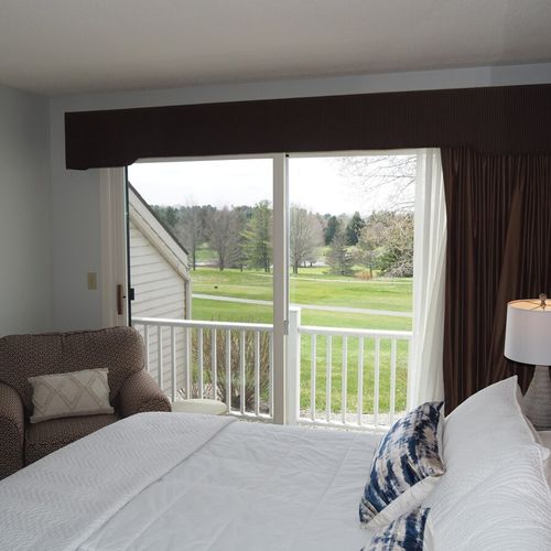 Master bedroom:  features a king-size bed, comfy chair, private balcony, nightstands with lamps, closet, its own television, and a private full en-suite bathroom!