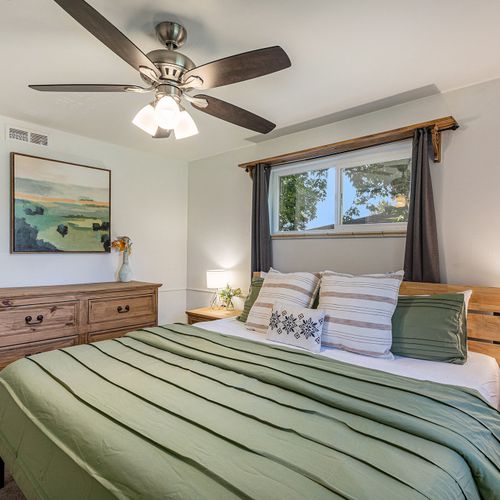 Unwind in style in the spacious upper-level bedroom, featuring a newly refurnished king-size bed with fresh linens.