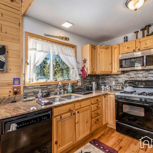 - start your mornings with sunlight pouring in through the large kitchen window with forest views
- double sink and dishwasher make cleanup a breeze after home cooked meals
- cozy cabin charm meets modern functionality in this inviting kitchen